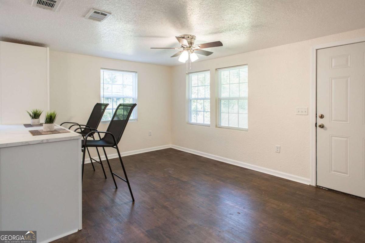 1410 Hazel Street Waycross, GA 31501 - Photo 5 of 21 a view of a dining room with furniture and a chandelier