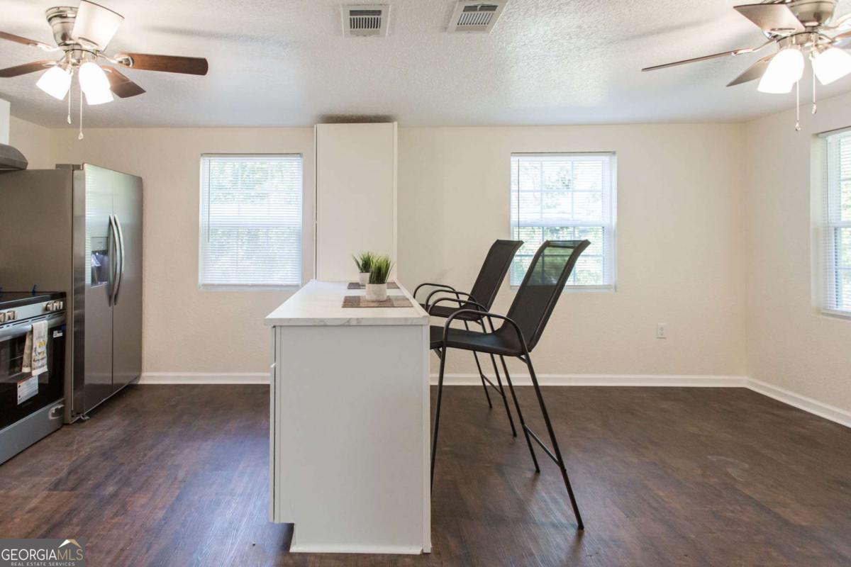 1410 Hazel Street Waycross, GA 31501 - Photo 6 of 21 a view of a workspace with furniture and a window