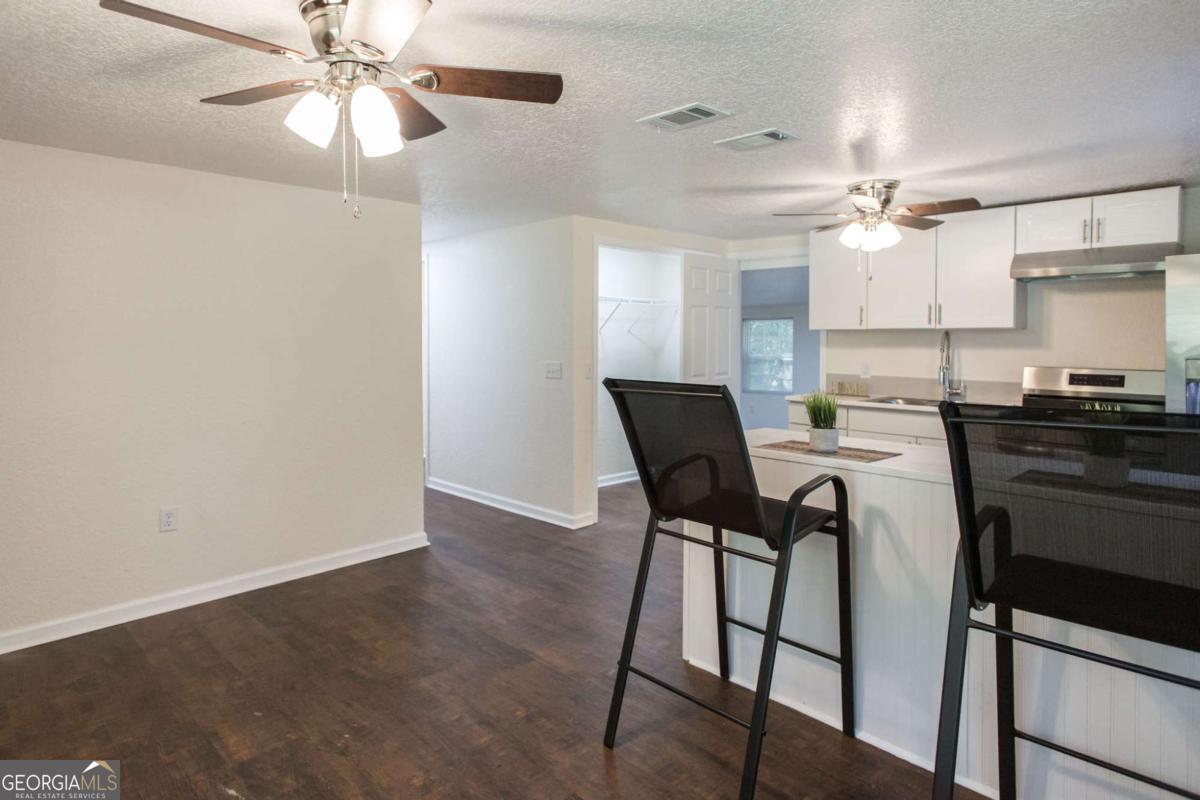 1410 Hazel Street Waycross, GA 31501 - Photo 7 of 21 a view of a dining room with furniture and a chandelier fan