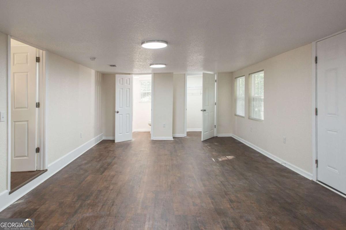1410 Hazel Street Waycross, GA 31501 - Photo 10 of 21 a view of empty room with wooden floor