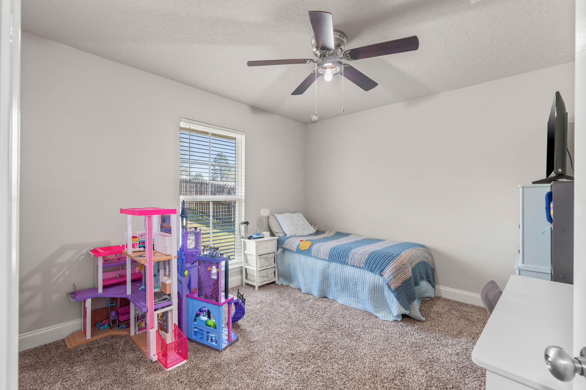4746 Chanson Crossing Crestview, FL 32539 - Photo 14 of 21 a living room with furniture and a flat screen tv