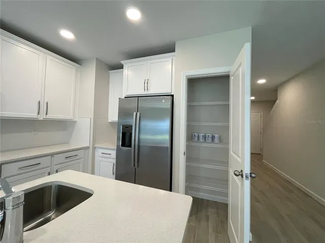 a kitchen with a sink and refrigerator
