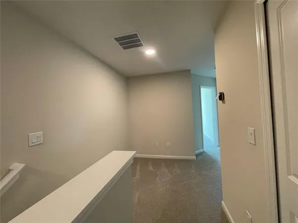 a bathroom with a bathtub shower sink vanity mirror and toilet