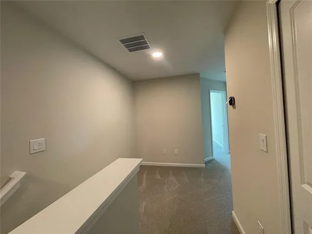 a bathroom with a bathtub shower sink vanity mirror and toilet