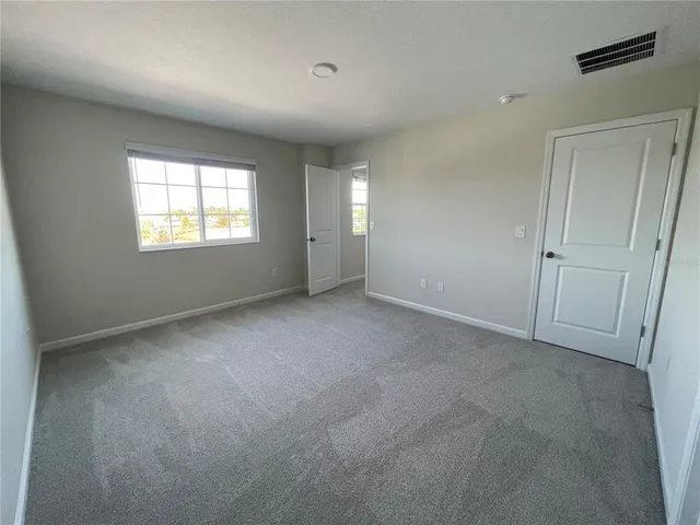 a bathroom with a granite countertop toilet and a shower