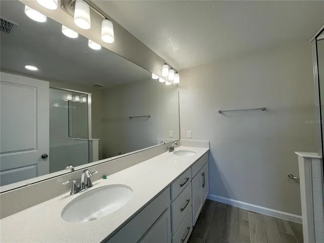 a empty room with wooden floor and windows