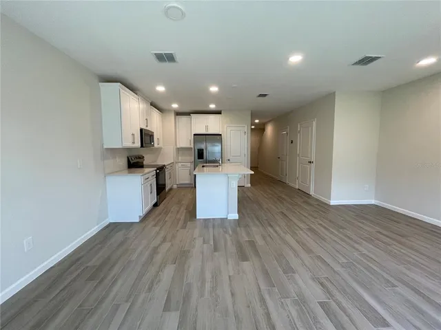 a view of kitchen with wooden floor and window