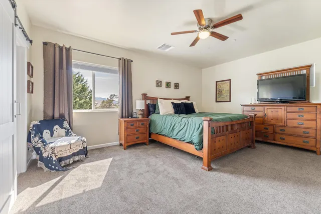a bedroom with bed and window