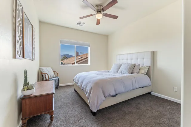 a bedroom with a bed lamp and furniture