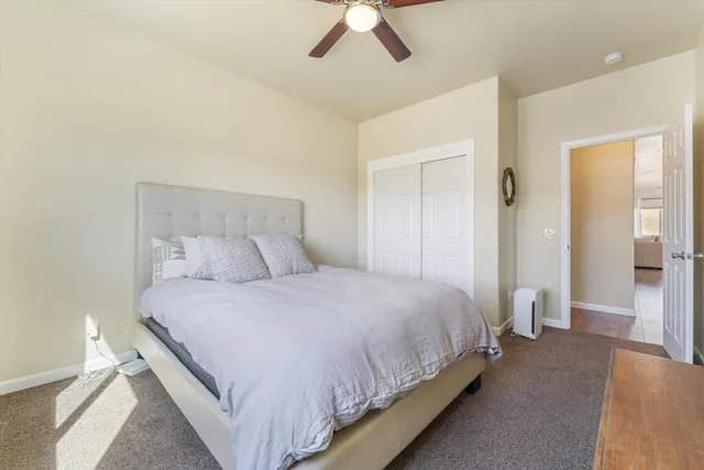 a bedroom with bed and a chandelier