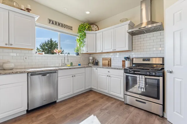 a kitchen with a sink stove and cabinets
