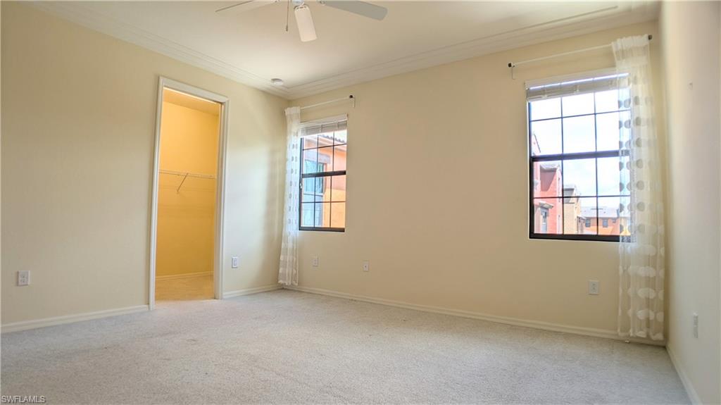 9067 Capistrano Street North, Unit 4503 Naples, FL 34113 - Photo 16 of 41 an empty room with windows