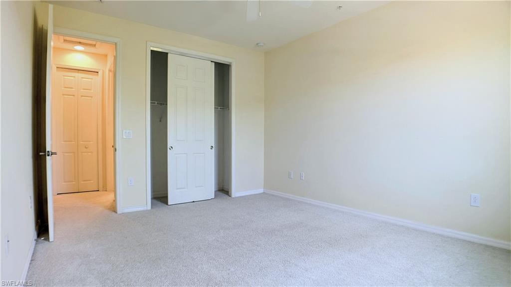 9067 Capistrano Street North, Unit 4503 Naples, FL 34113 - Photo 20 of 41 an empty room with windows