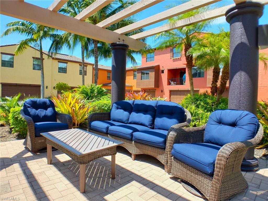 9067 Capistrano Street North, Unit 4503 Naples, FL 34113 - Photo 28 of 41 a view of a chairs and table in the patio