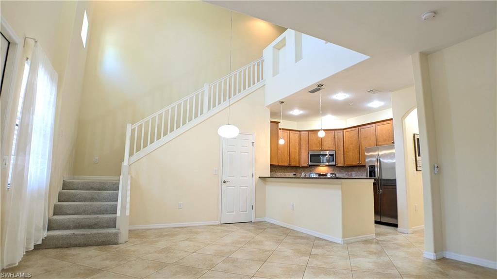 9067 Capistrano Street North, Unit 4503 Naples, FL 34113 - Photo 5 of 41 a view of kitchen with kitchen island and stainless steel appliances