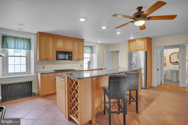 a view of a big house with a big yard and large trees