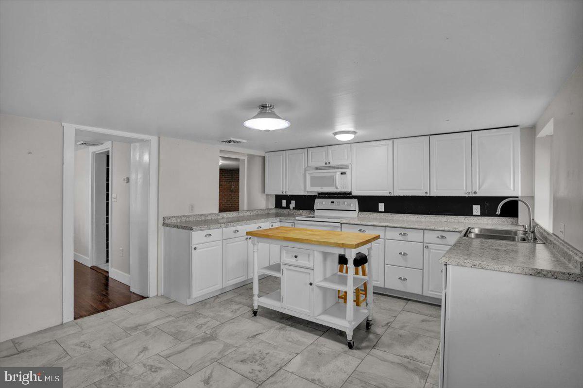 739 Boar Road Mohrsville, PA 19541 - Photo 64 of 98 a kitchen with a stove a sink and a refrigerator