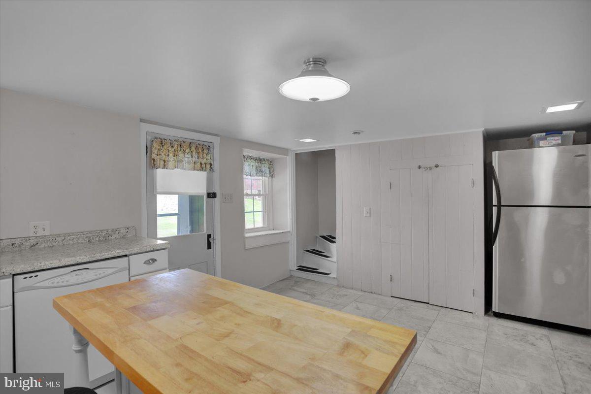 739 Boar Road Mohrsville, PA 19541 - Photo 66 of 98 a kitchen with stainless steel appliances granite countertop a refrigerator a sink and white cabinets