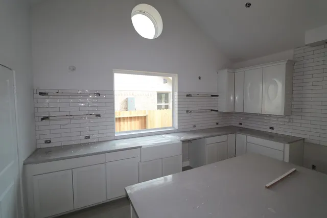 a view of a room that has a bed and a chair in it