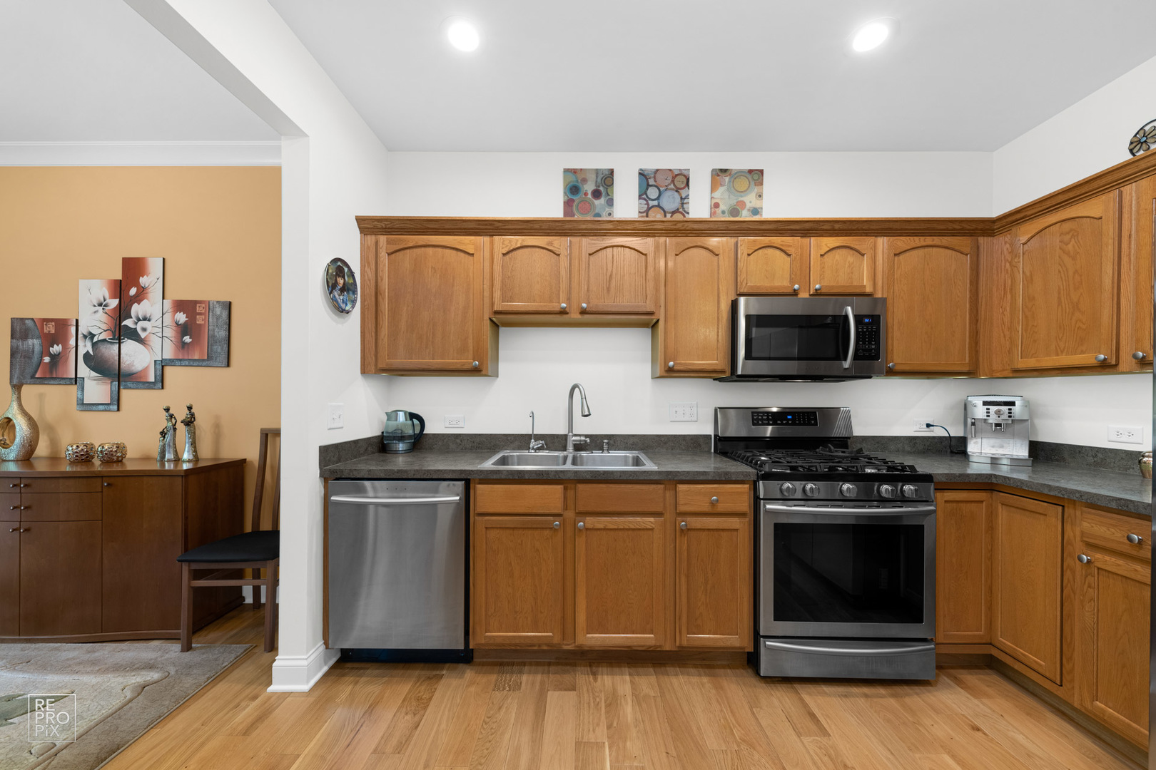Undisclosed Address Elgin, IL 60120 - Photo 11 of 22 a kitchen with stainless steel appliances a stove top oven a sink and cabinets