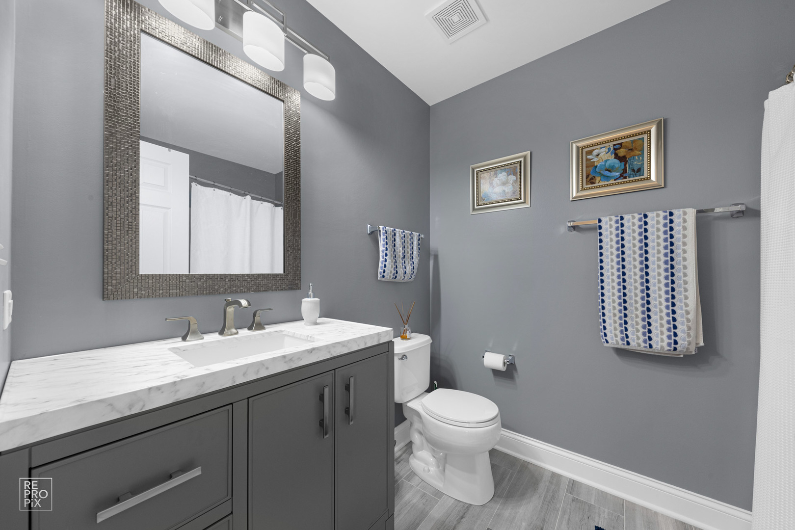 Undisclosed Address Elgin, IL 60120 - Photo 17 of 22 a bathroom with a toilet sink and mirror