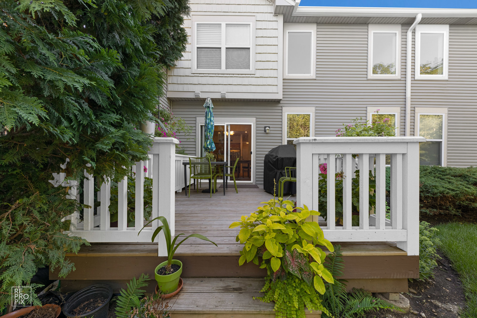 Undisclosed Address Elgin, IL 60120 - Photo 21 of 22 a view of a house with potted plants and a table and chairs