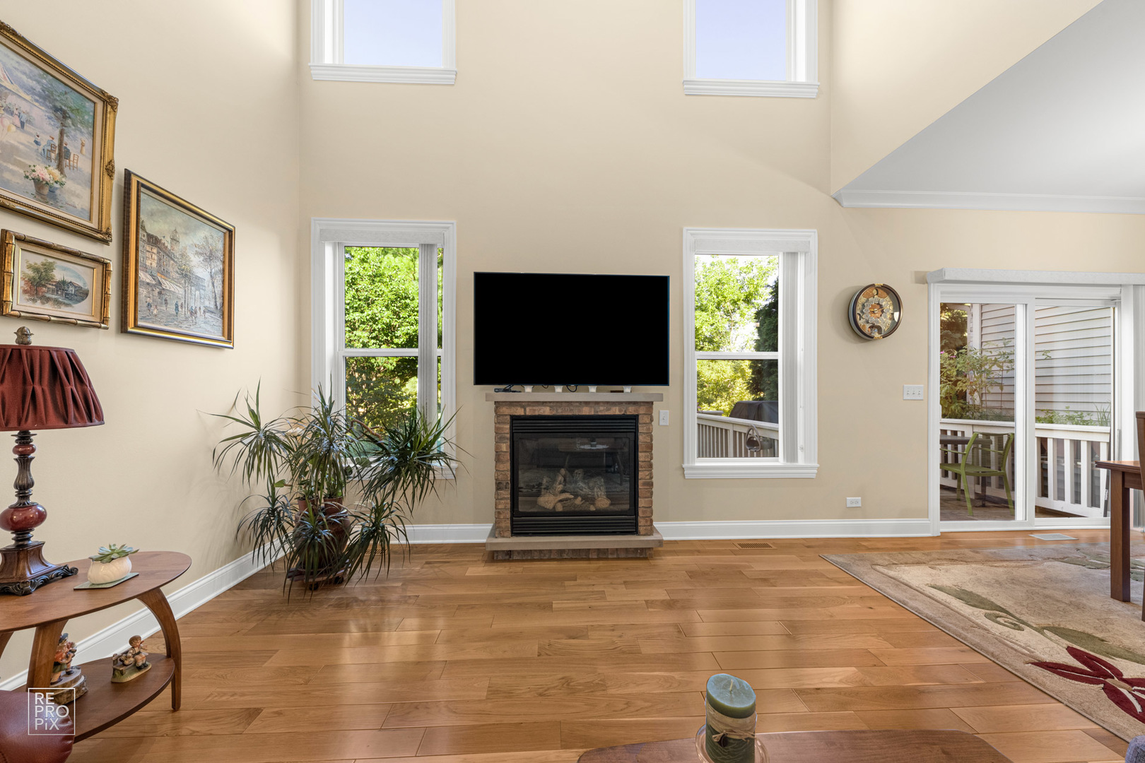Undisclosed Address Elgin, IL 60120 - Photo 5 of 22 a living room with furniture a flat screen tv and a fireplace