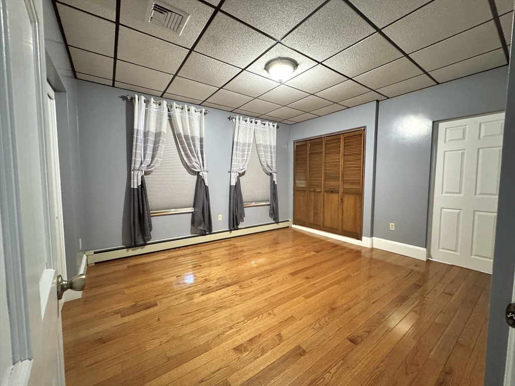 22 Dana Street, Unit 1 Somerville, MA 02145 - Photo 13 of 22 a view of empty room with wooden floor