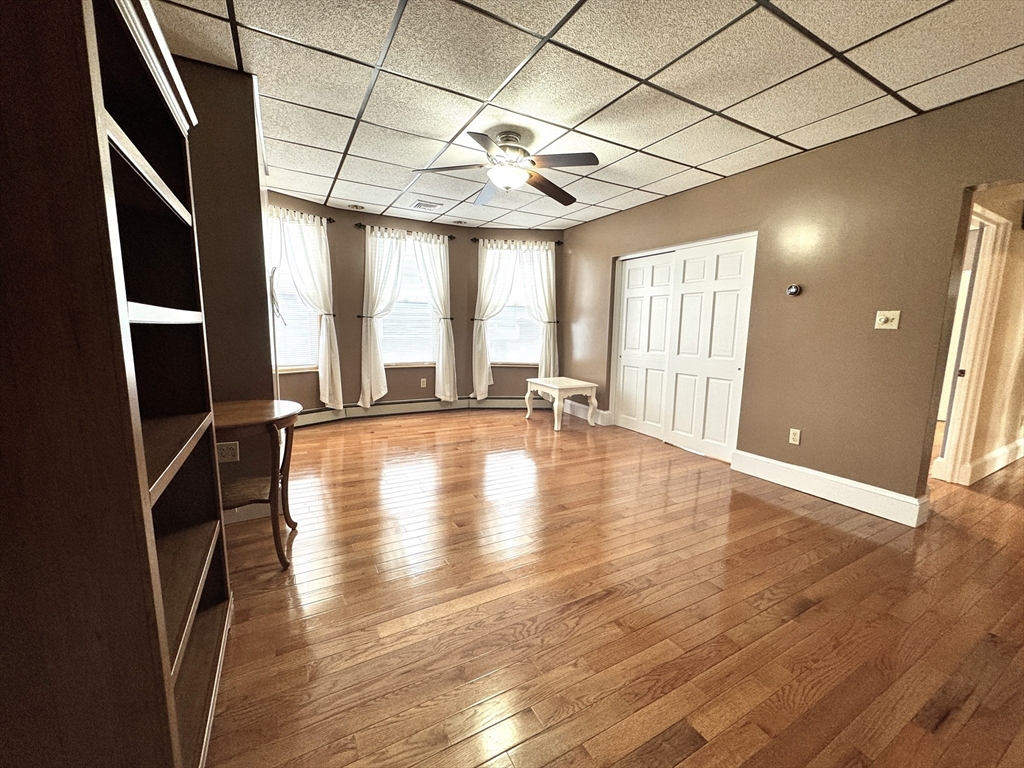 22 Dana Street, Unit 1 Somerville, MA 02145 - Photo 7 of 22 an empty room with wooden floor and windows