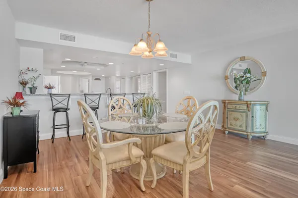 a view of a dining room with furniture and wooden floor