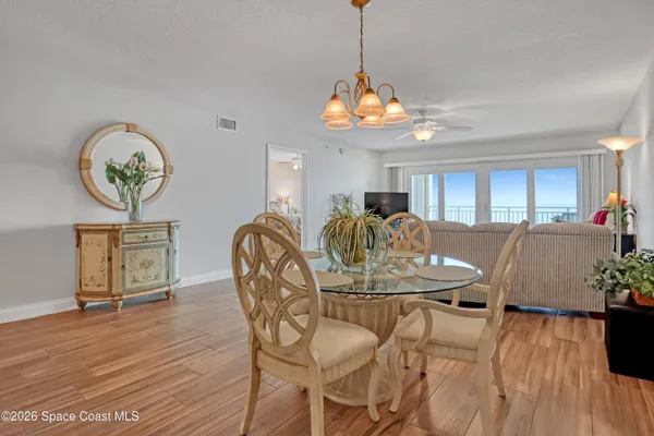 a view of a dining room with furniture wooden floor and chandelier