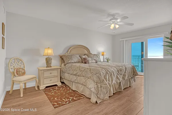 a bedroom with a bed and lamp chandelier