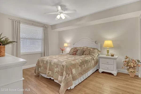 a bedroom with a bed and a mirror on the dresser