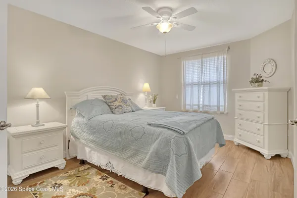 a spacious bedroom with a bed and a chandelier