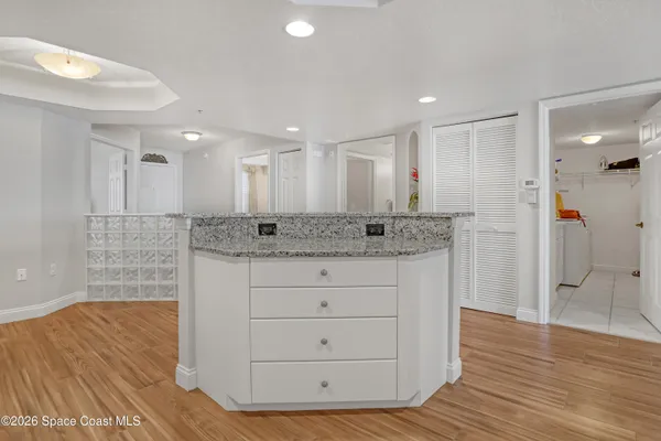 a bathroom with a granite countertop sink mirror and shower