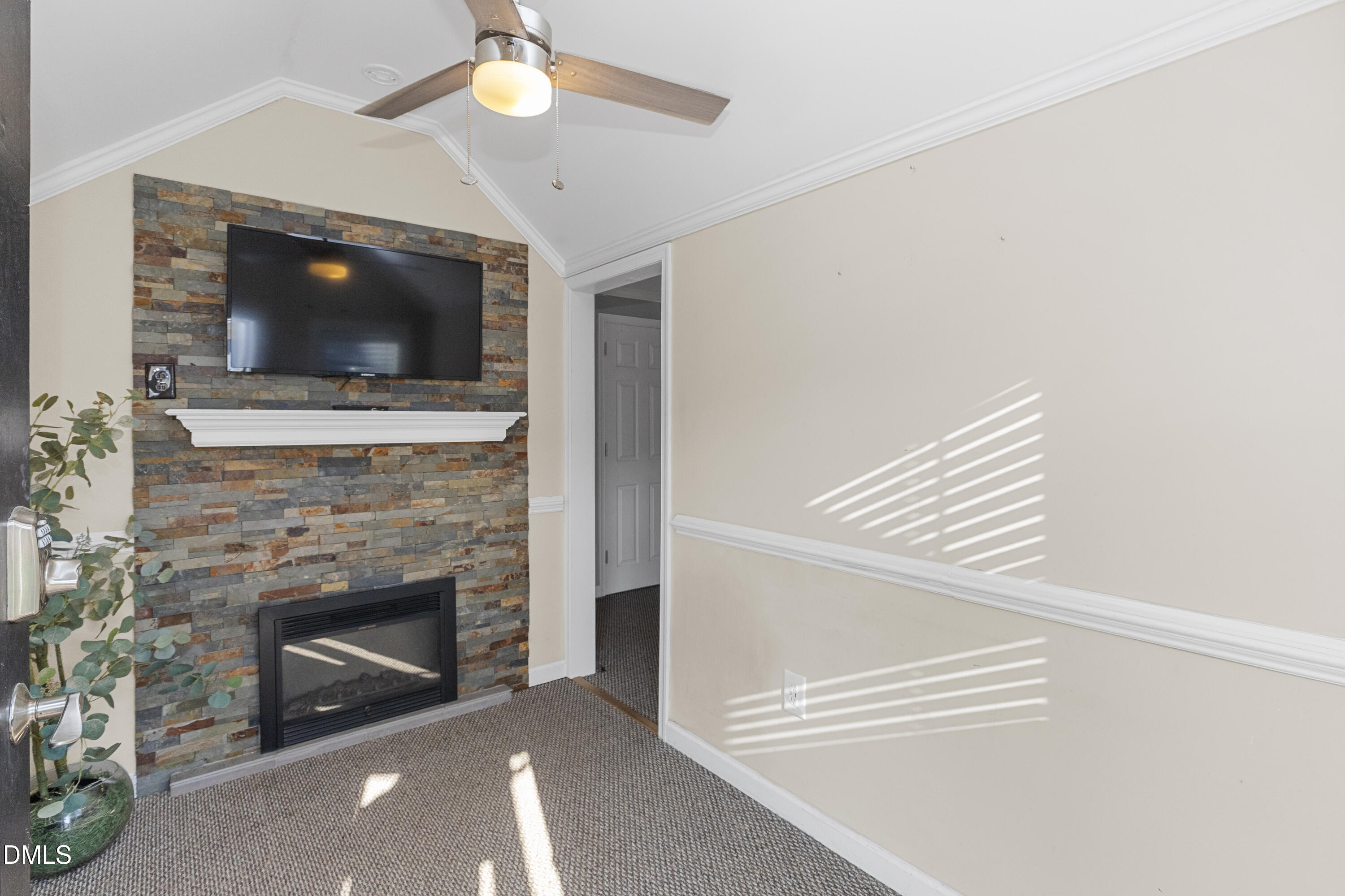 199 Iris Bryant Road Erwin, NC 28339 - Photo 24 of 33 a living room with a fireplace and a ceiling fan