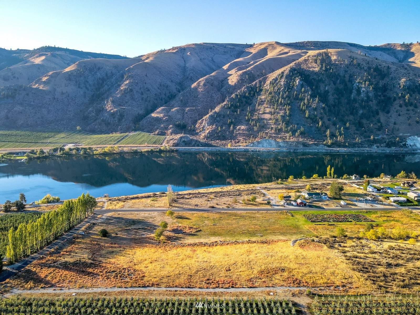 0 New Road Chelan, WA 98816 - Photo 3 of 10 a view of a lake with a mountain