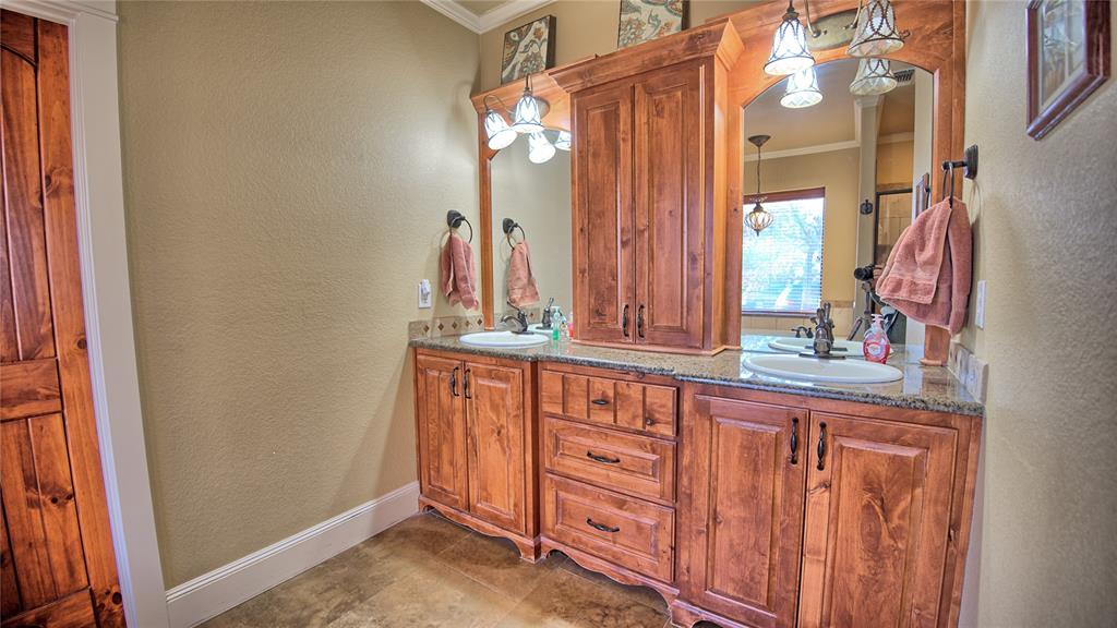 202 Storey Road Nocona, TX 76255 - Photo 11 of 40 a bathroom with a sink and a mirror