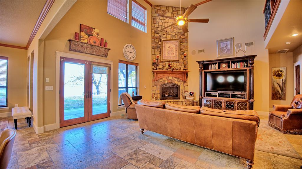 202 Storey Road Nocona, TX 76255 - Photo 2 of 40 a living room with furniture and a flat screen tv