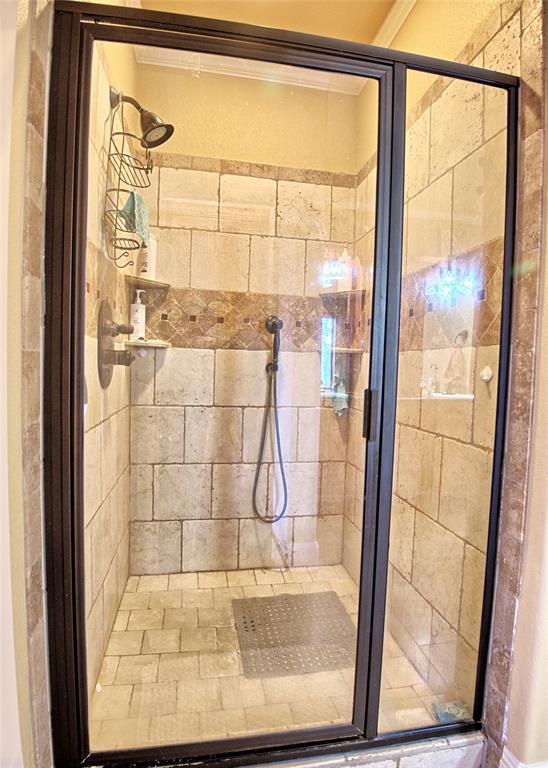 202 Storey Road Nocona, TX 76255 - Photo 32 of 40 a bathroom with a glass shower door