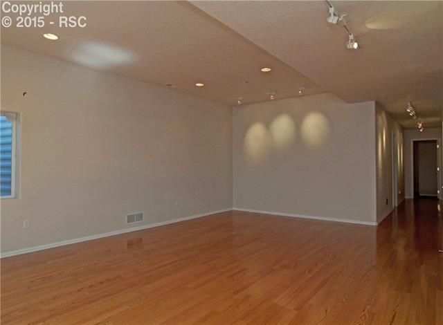 8756 Del Rio Road Peyton, CO 80831 - Photo 22 of 31 Large Rec Room with wood laminate floors