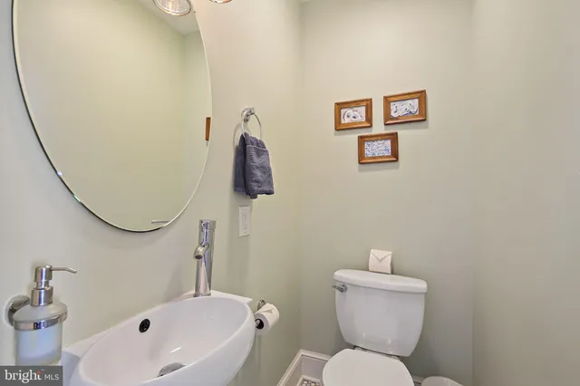 a white toilet sitting next to a bathroom sink