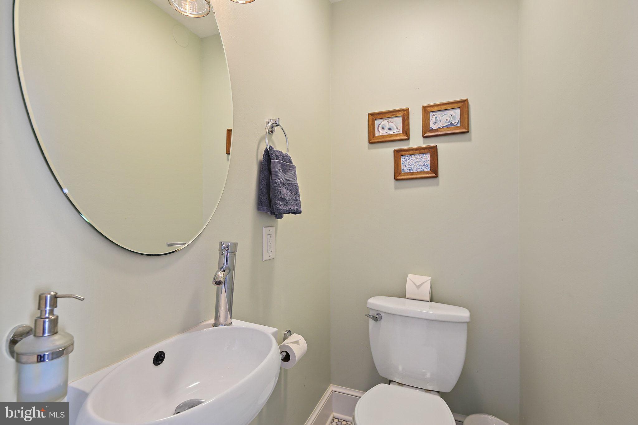 32 East Street Annapolis, MD 21401 - Photo 14 of 34 a white toilet sitting next to a bathroom sink