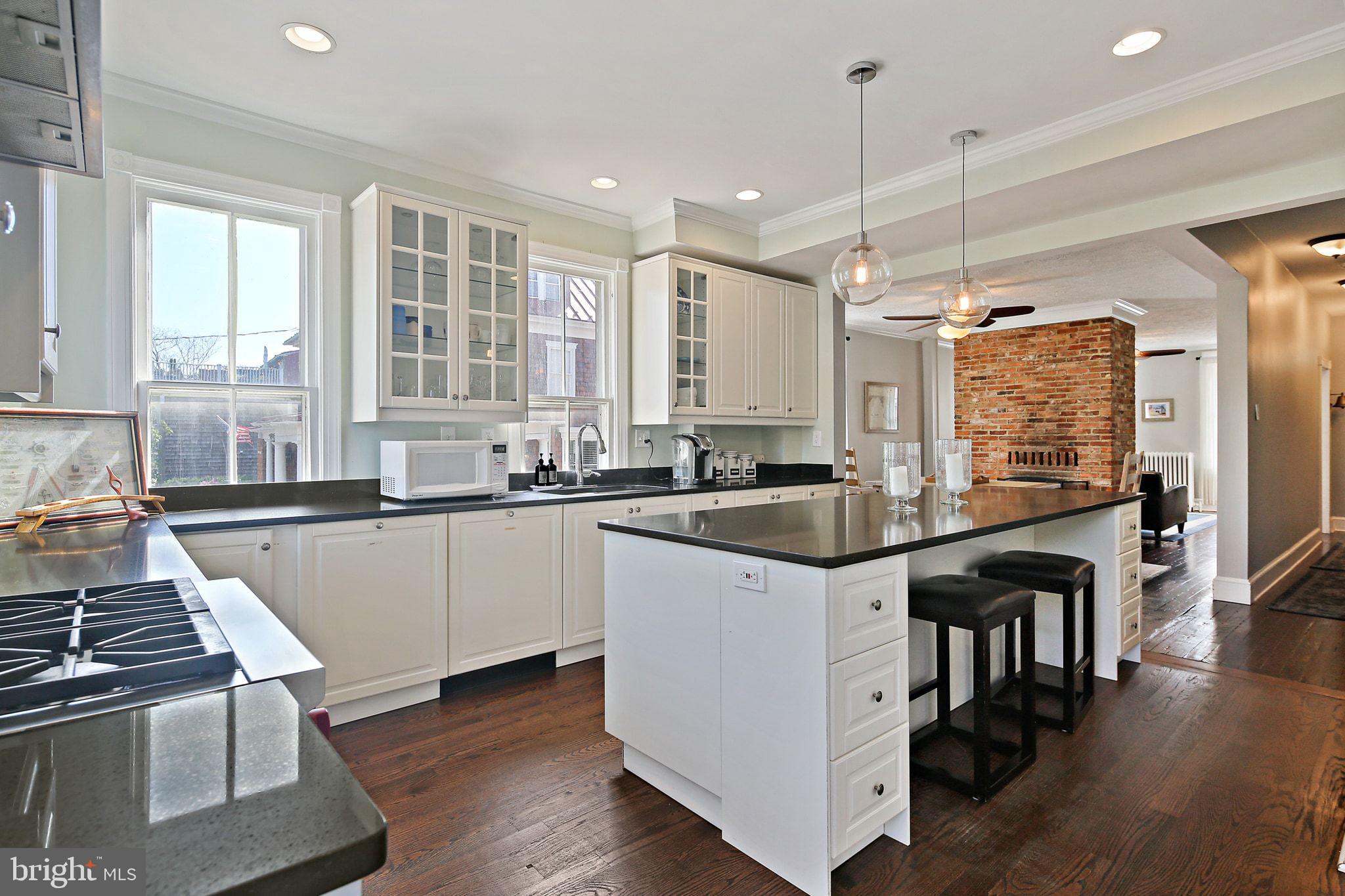 32 East Street Annapolis, MD 21401 - Photo 17 of 34 a kitchen with stainless steel appliances granite countertop a stove and a sink