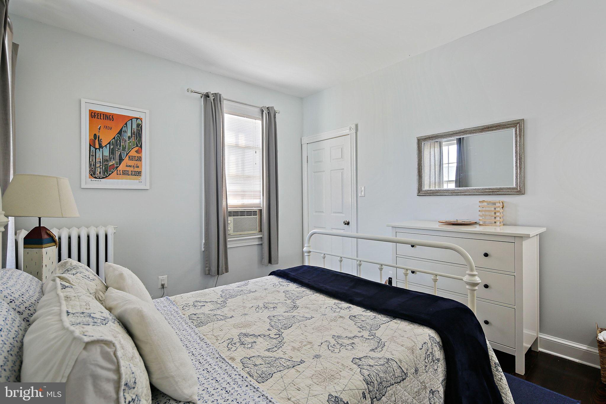 32 East Street Annapolis, MD 21401 - Photo 22 of 34 a bedroom with a bed and a lamp on dresser