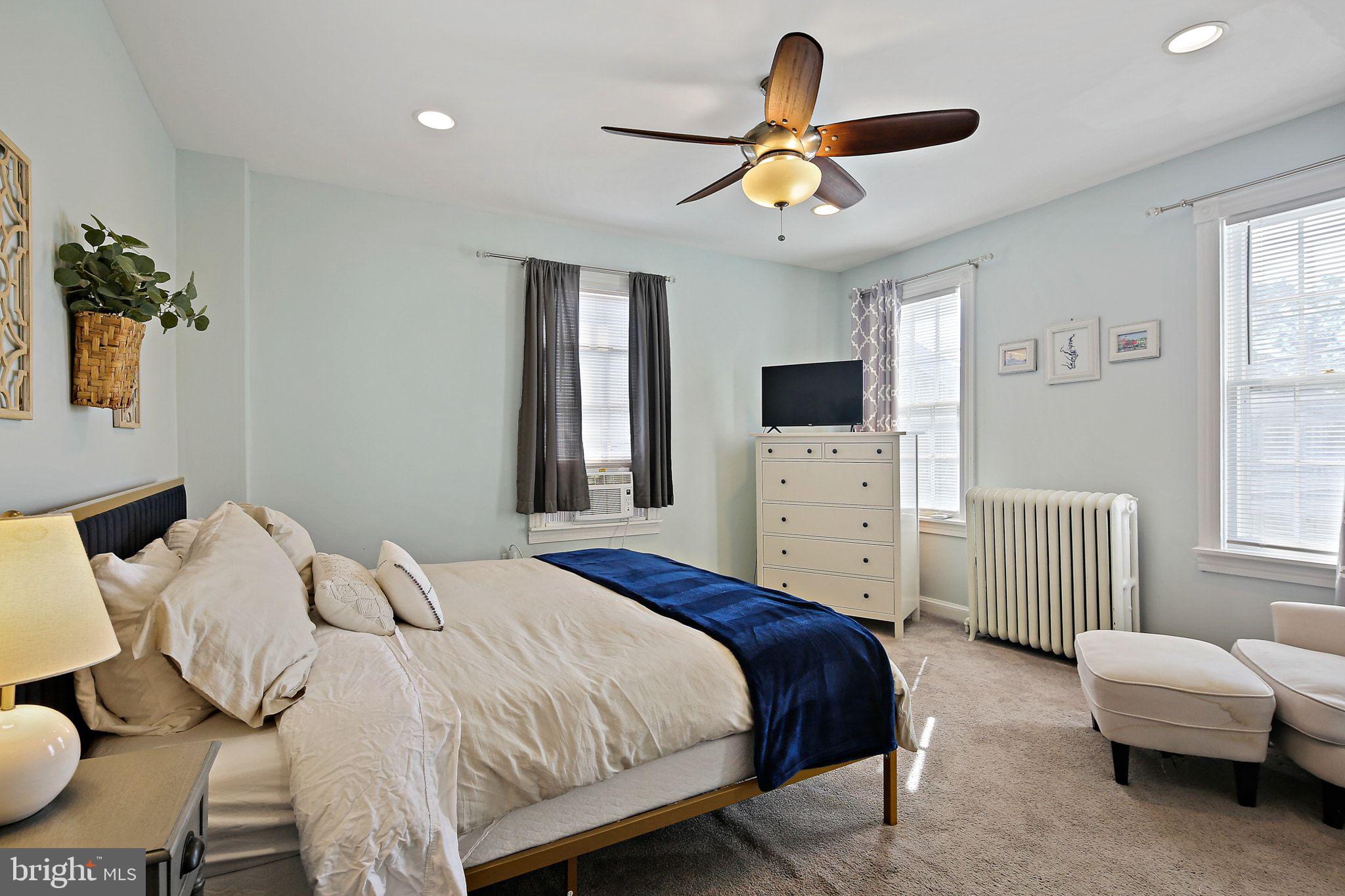 32 East Street Annapolis, MD 21401 - Photo 24 of 34 a bedroom with a bed and a chandelier