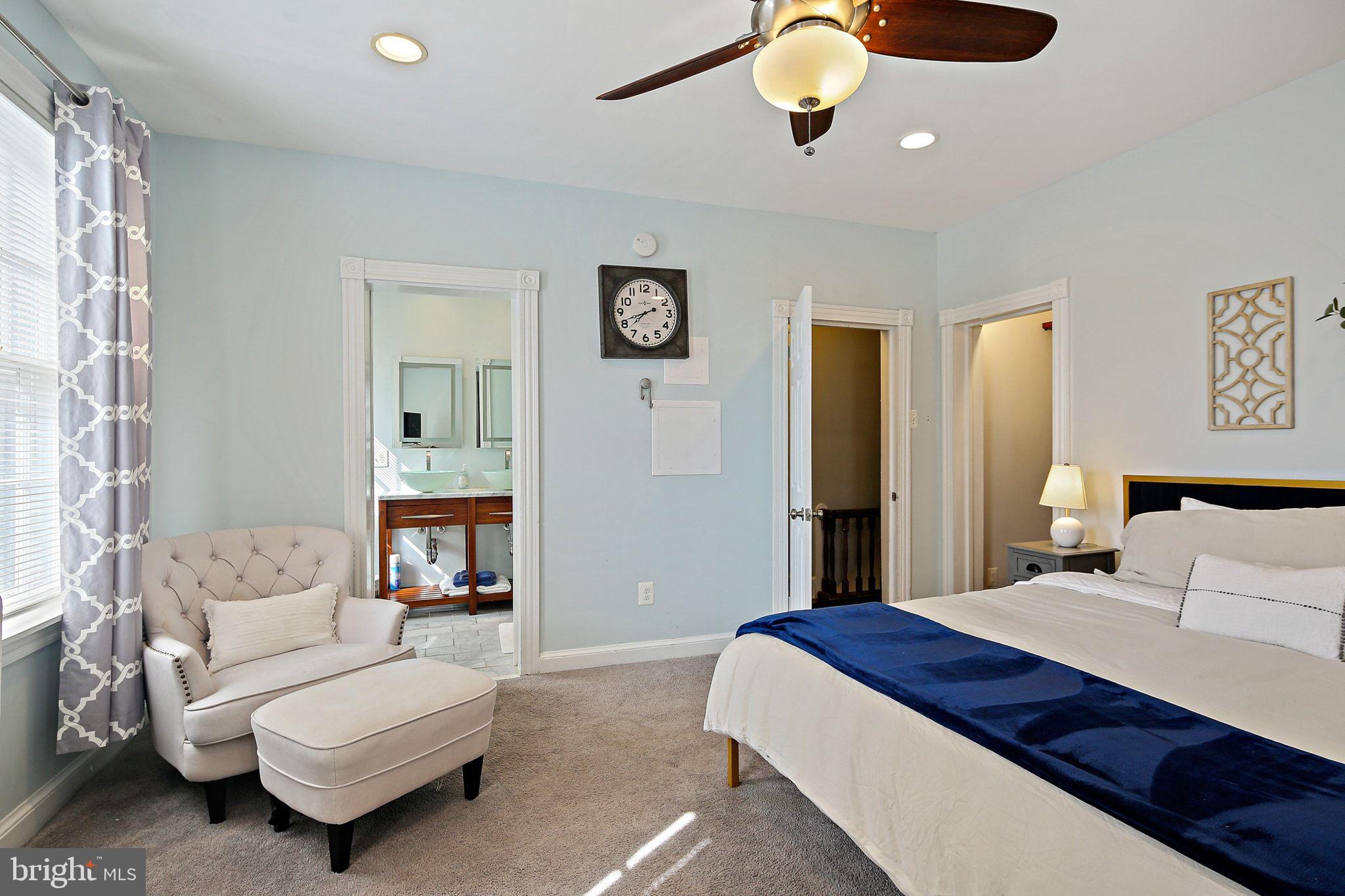 32 East Street Annapolis, MD 21401 - Photo 26 of 34 a bedroom with a bed and a chandelier