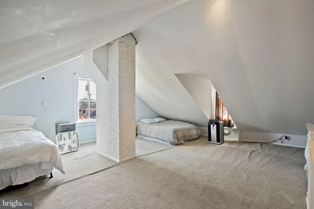 a bedroom with a bed and a view of en suite bathroom