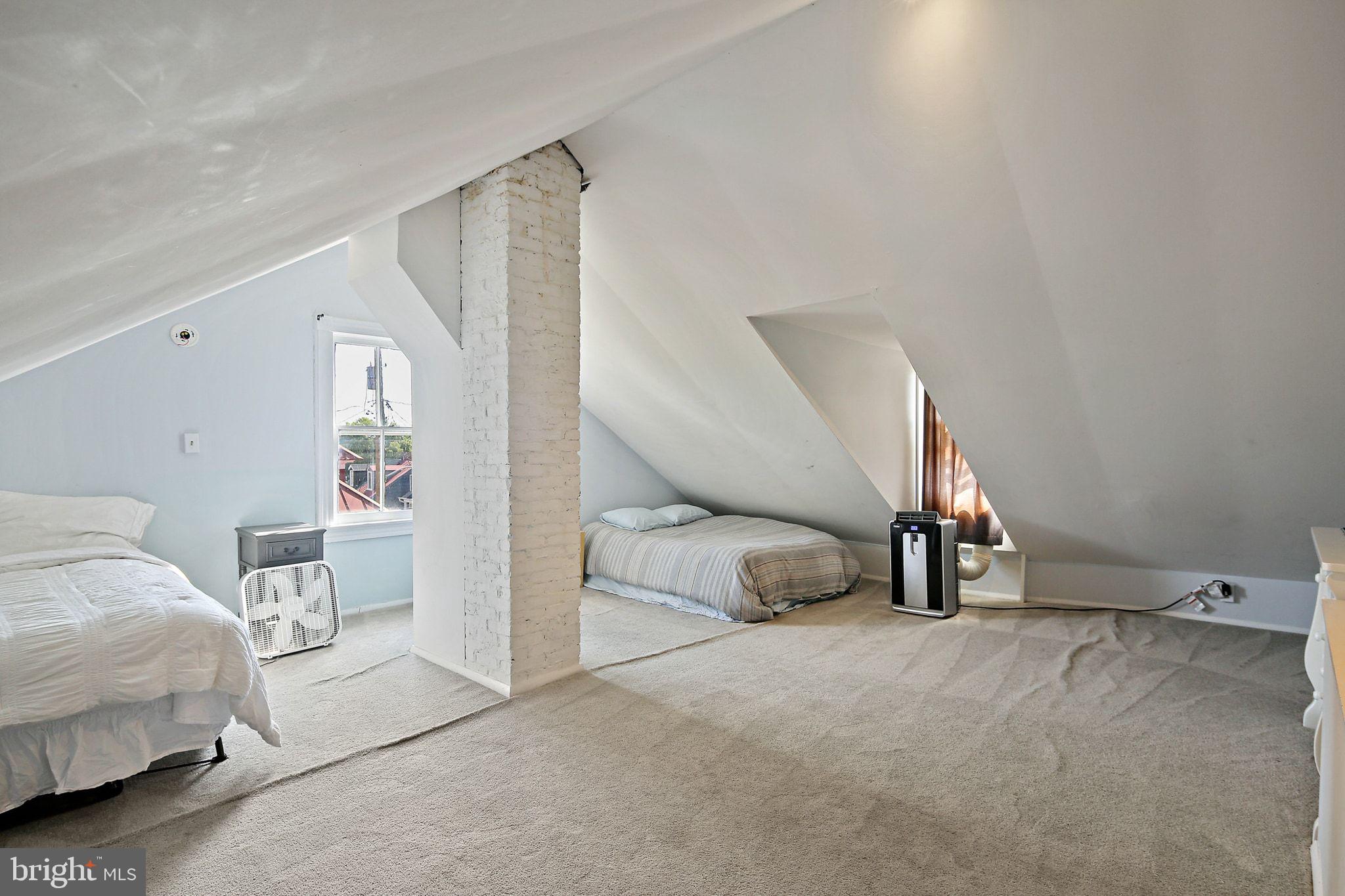 32 East Street Annapolis, MD 21401 - Photo 28 of 34 a bedroom with a bed and a view of en suite bathroom