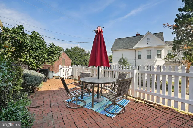 a view of a chairs and table in patio with a fire pit